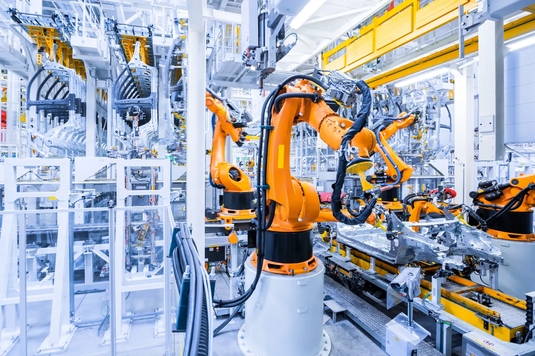Industrial robot arms welding on an automated automotive production line
