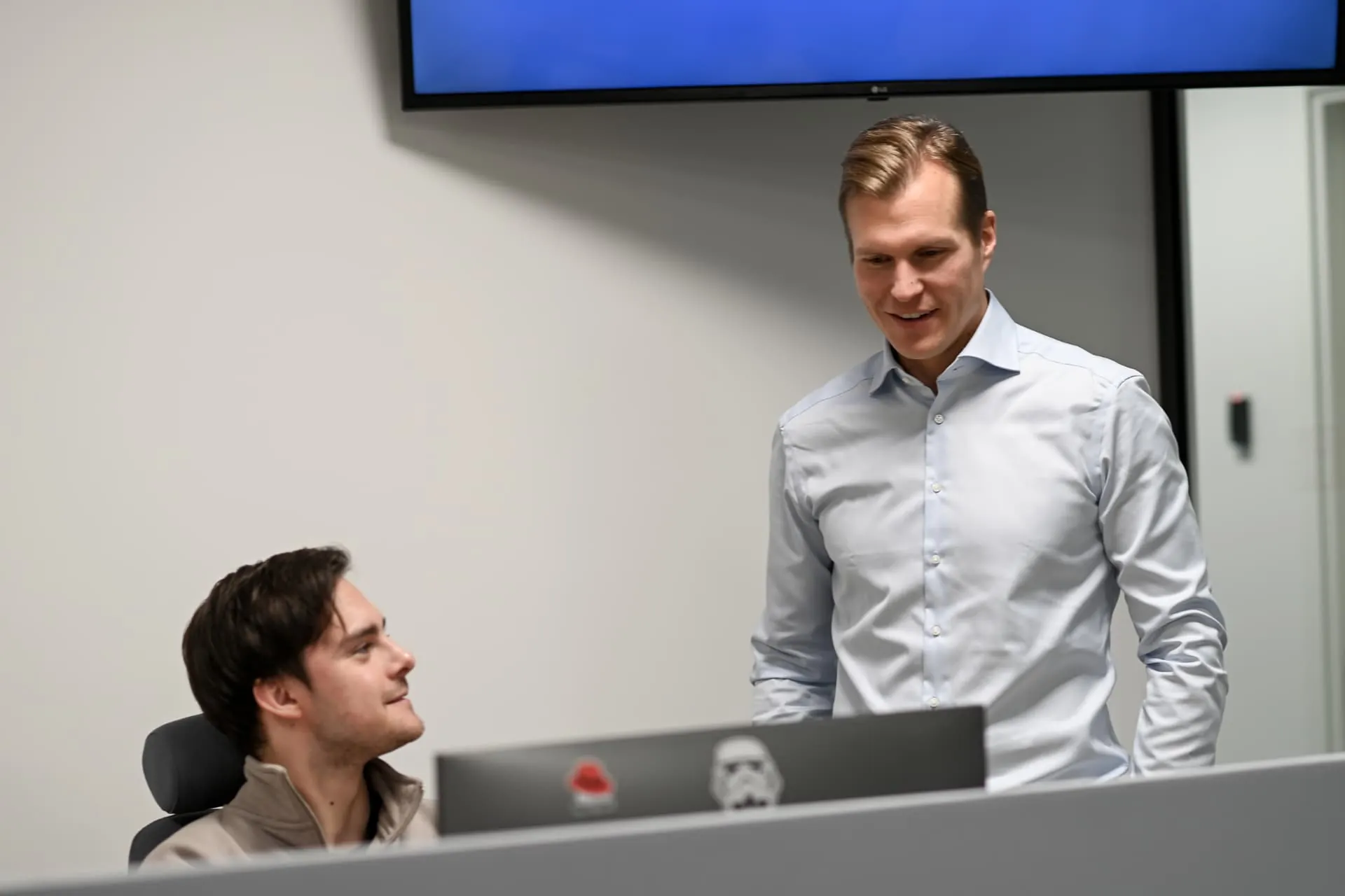 Two colleagues discussing work at a desk