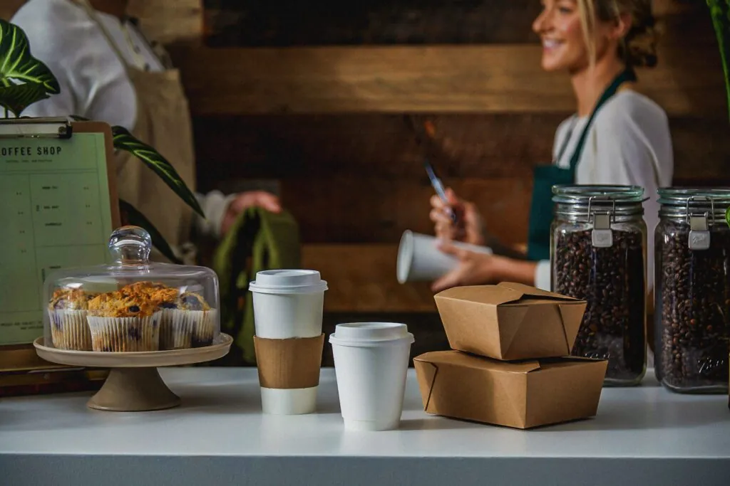 Paperboard cups and food boxes at a coffee shop counter