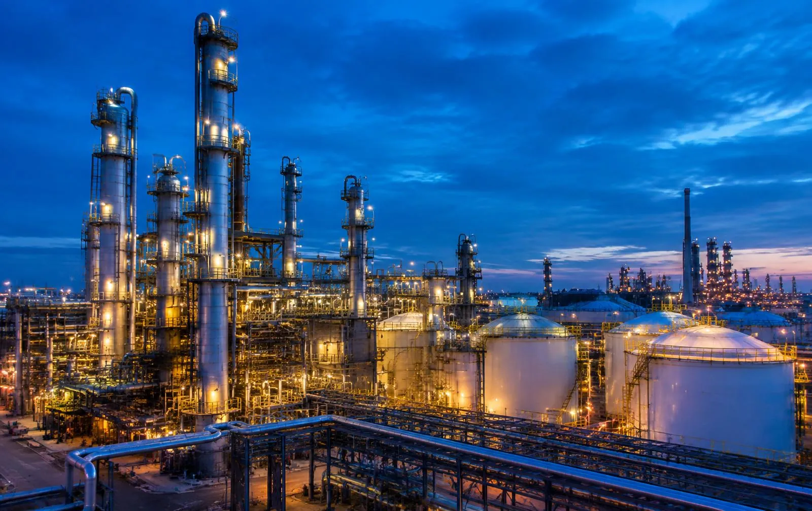Petrochemical plant with lit distillation columns at dusk